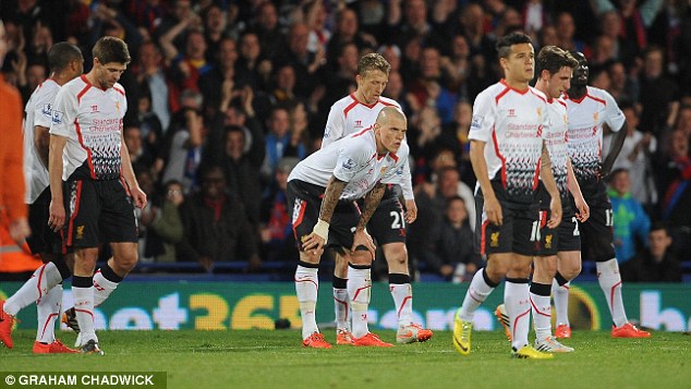 Down and out: Liverpool looked a beaten team, with almost everybody