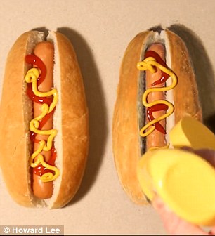 The artist adds mustard to the hot dog