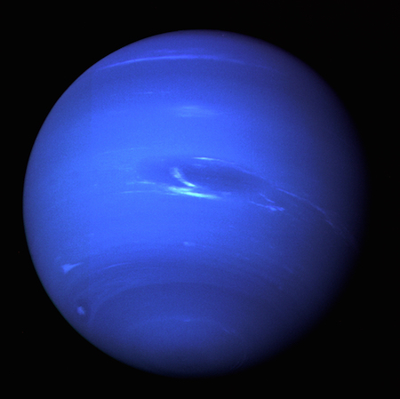 A photo of a full side of Neptune, showing a dark blue color and a few white cloud streaks.