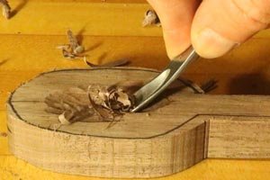 Hand carving the bowl on a wooden spoon.