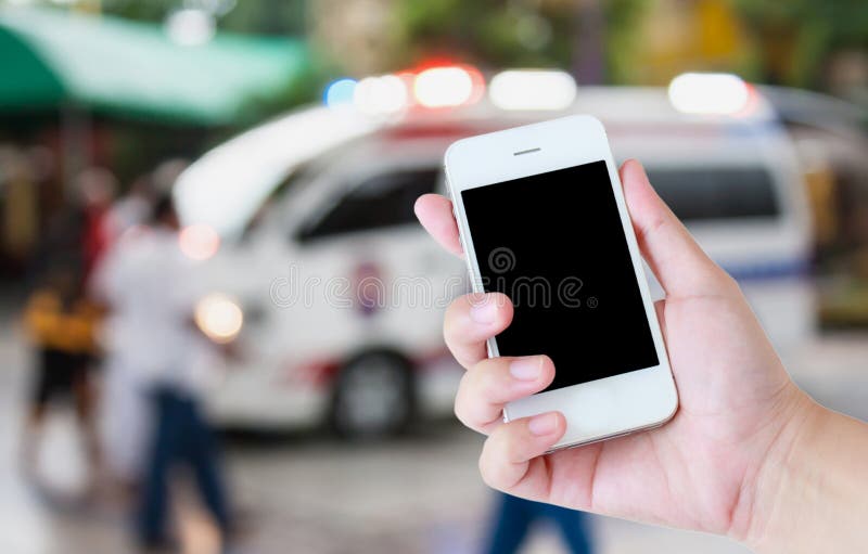 Ambulance responding to an emergency call. Hand hold smartphone with Ambulance responding to an emergency call background royalty free stock images Ambulance responding to an emergency call. Hand hold smartphone with Ambulance responding to an emergency call background royalty free stock images