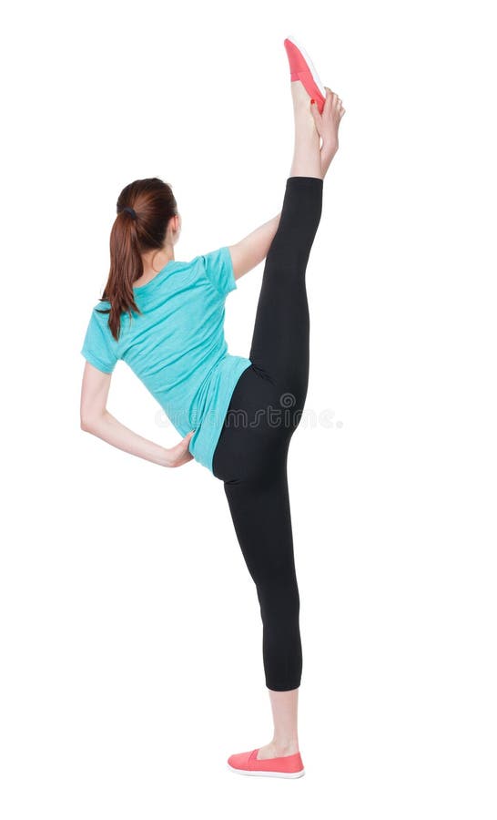 Back view of standing young beautiful woman in sport dress involved in Pilates. royalty free stock photo