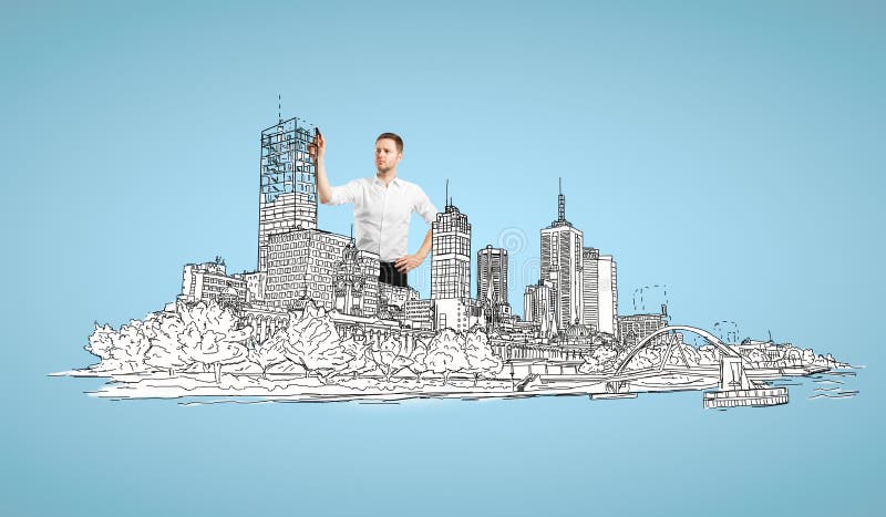 Businessman drawing abstract city. On blue background royalty free stock photo