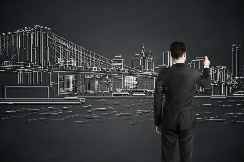 Businessman drawing city. Back view of young businessman drawing city on gray wall. Art concept stock photography