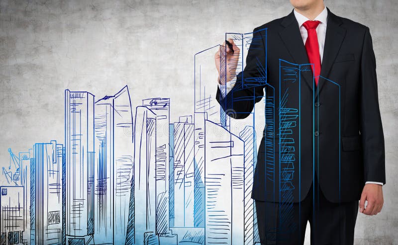 Businessman drawing city. Buildings on gray background stock photography