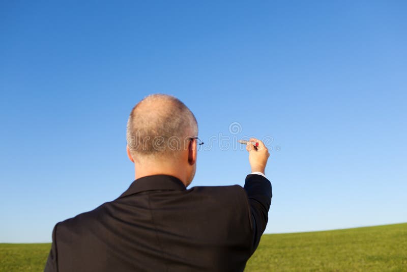 Businessman Drawing On Sky. Rear view of businessman drawing on clear sky royalty free stock photography Businessman Drawing On Sky. Rear view of businessman drawing on clear sky royalty free stock photography