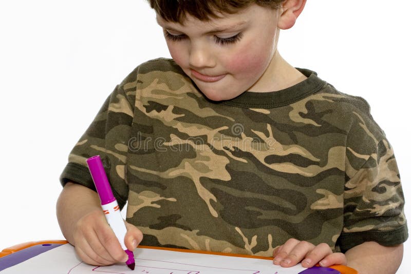 Child drawing. Young child drawing at a table with markers stock photos