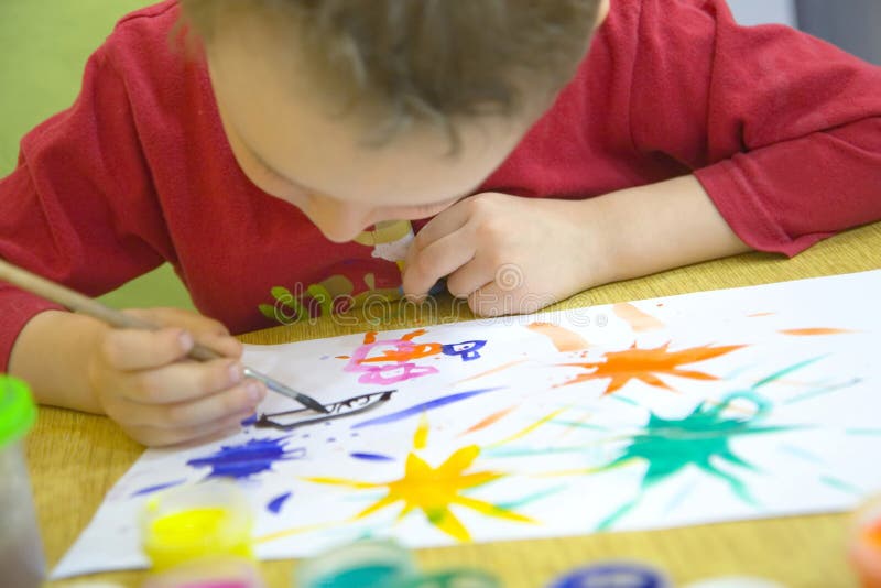 Child drawing. Picture by artistic paints stock image