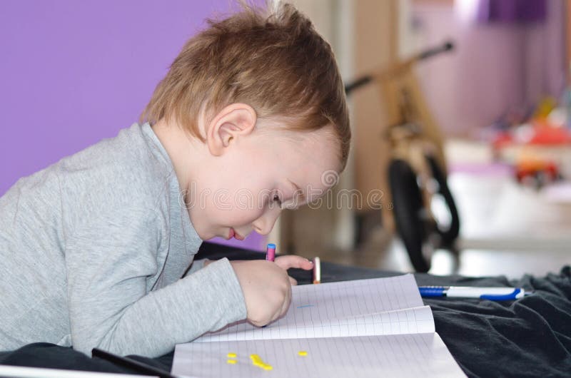 Child drawing at home. Cute blond Child playing at home, drawing royalty free stock images
