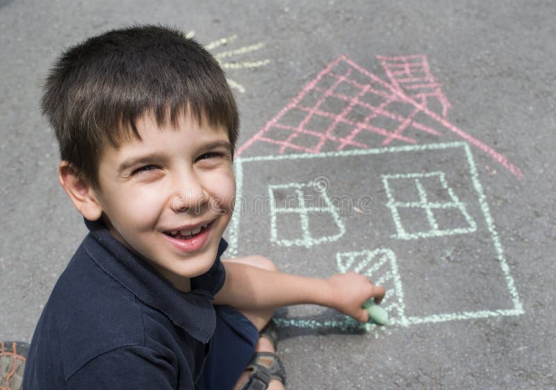 Child drawing sun and house on asphal. T in a park royalty free stock images