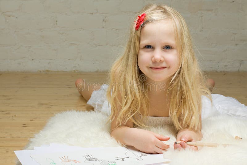 Child girl drawing. Blond child girl drawing home stock photography