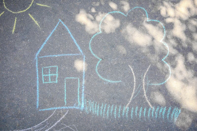 Child`s chalk drawing of house and tree on asphalt royalty free illustration