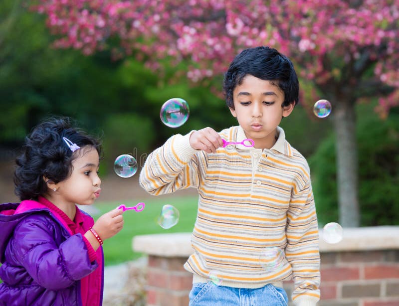 Children Blowing Bubbles in Their Yard royalty free stock photo Children Blowing Bubbles in Their Yard royalty free stock photo