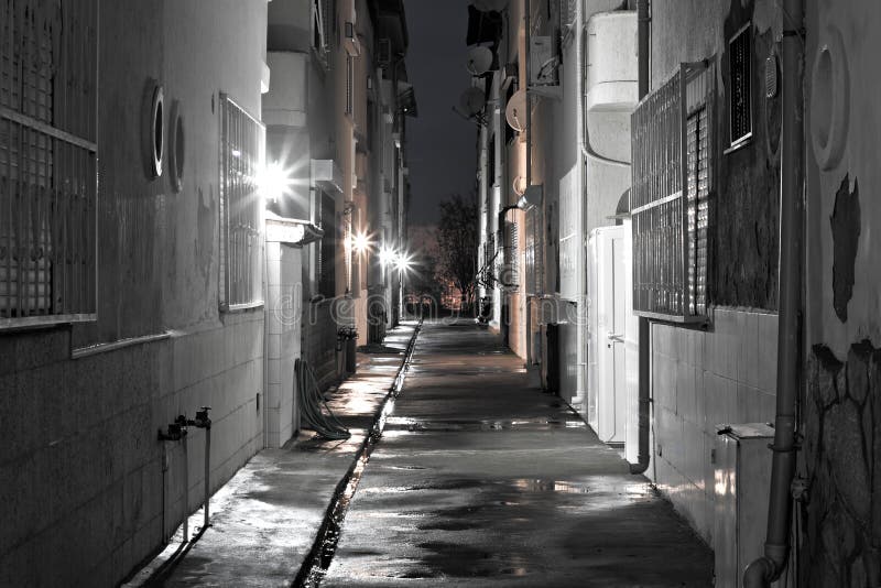 Dark back alley on a wet night royalty free stock photo