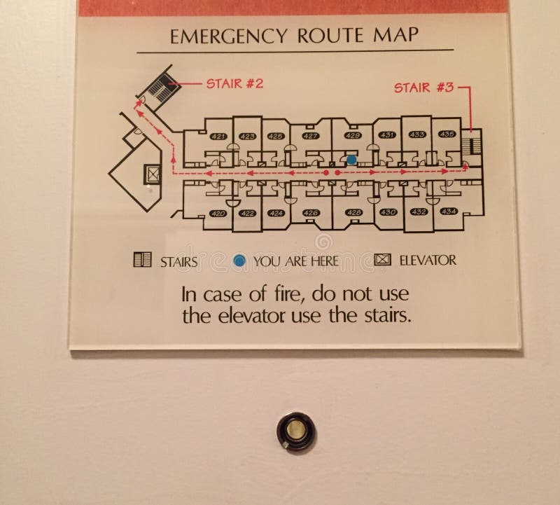 Emergency Exit Route. Site and floor emergency exit plan on door with peep hole at hotel royalty free stock images Emergency Exit Route. Site and floor emergency exit plan on door with peep hole at hotel royalty free stock images