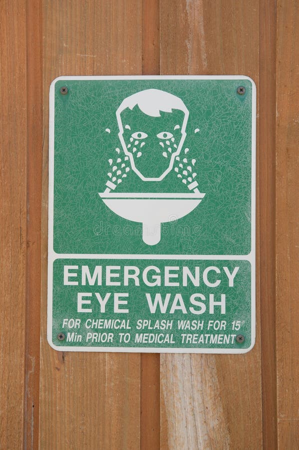 Emergency Eye Wash. Sign on a wooden background stock image Emergency Eye Wash. Sign on a wooden background stock image