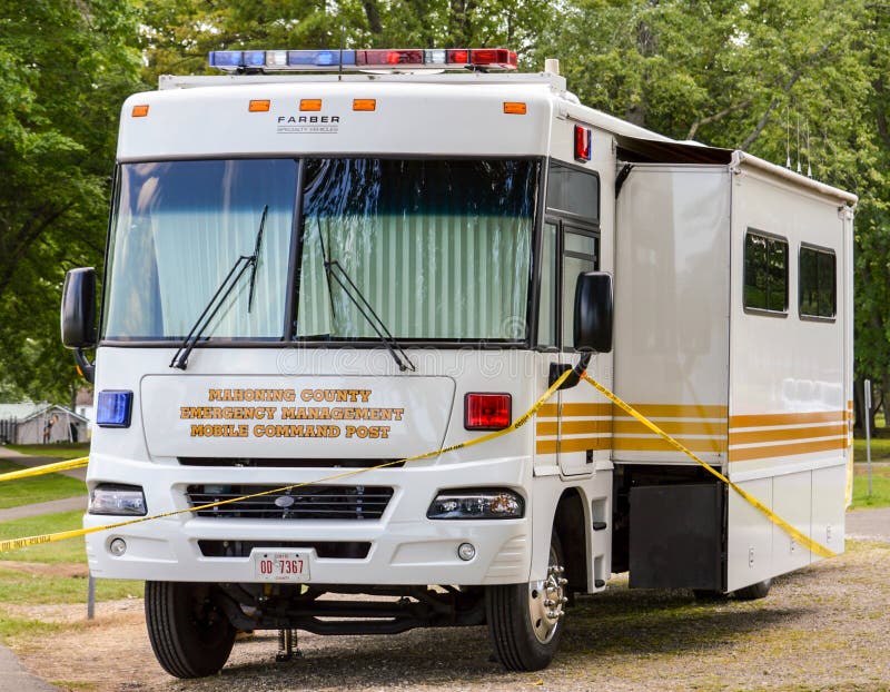 Emergency Management Mobile Command Post Vehicle. An Emergency Management Mobile Command Post vehicle at the scene of a tragedy with police tape around the area royalty free stock images Emergency Management Mobile Command Post Vehicle. An Emergency Management Mobile Command Post vehicle at the scene of a tragedy with police tape around the area royalty free stock images
