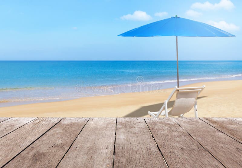 Empty perspective old wooden balcony terrace floor with white wooden beach chair and blue parasol on tropical beach. With blue sky royalty free stock photos Empty perspective old wooden balcony terrace floor with white wooden beach chair and blue parasol on tropical beach. With blue sky royalty free stock photos