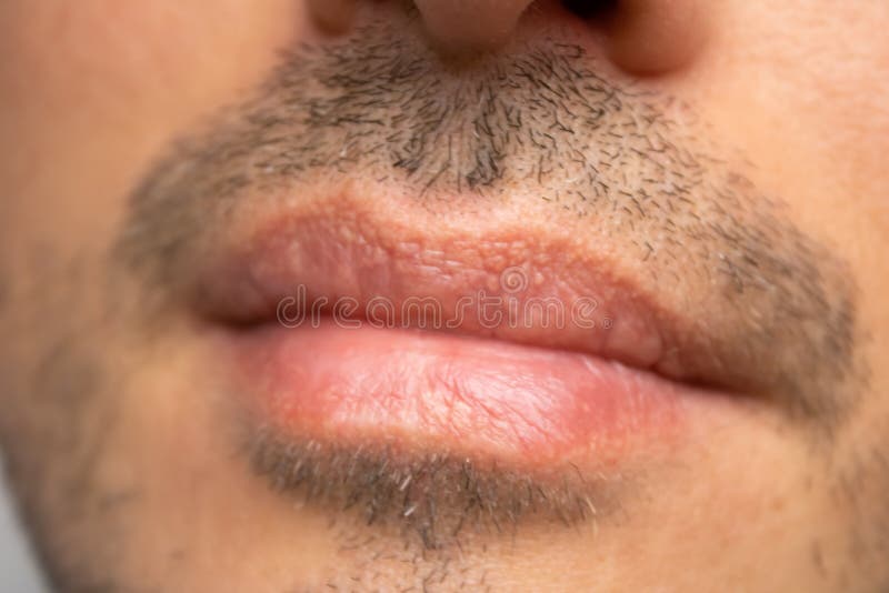 Male NU Lips. Young man closeup lips, male permanent make up, men`s bristle. Esthetician therapy and permanent makeup for men.Male NU Lips.Young man closeup royalty free stock photos