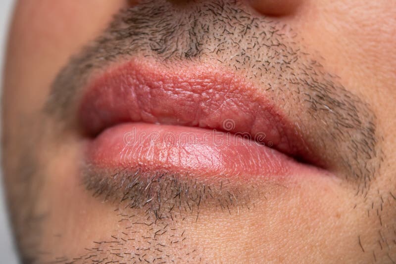 Male NU Lips. Young man closeup lips, male permanent make up, men`s bristle. Esthetician therapy and permanent makeup for men.Male NU Lips.Young man closeup stock images