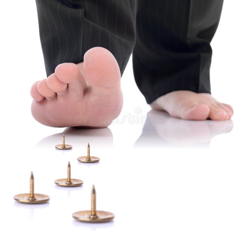 Foor and pin. Concept of unforseen problem or danger ahead, foot stepping on a pin isolated on a white background stock photography