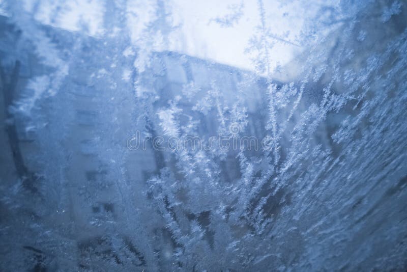 Frost on a car window. Drawing on glass from ice. Cold winter. Frost.  stock images