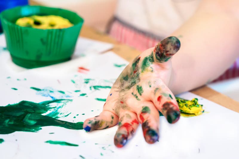 Hands of child girl boy dirty in childrens finger paint studying drawing art royalty free stock photos Hands of child girl boy dirty in childrens finger paint studying drawing art royalty free stock photos