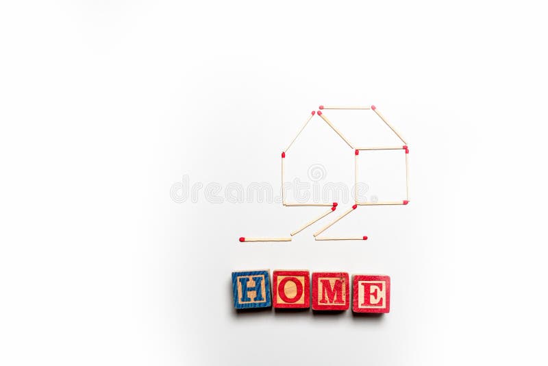 House made of matchsticks with the word `home` written in blocks underneath. House made of matchsticks on an isolated white background with the word `home` royalty free stock photography