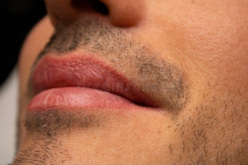 Male NU Lips. Young man closeup lips, male permanent make up, men`s bristle. Esthetician therapy and permanent makeup for men.Male NU Lips.Young man closeup stock photography