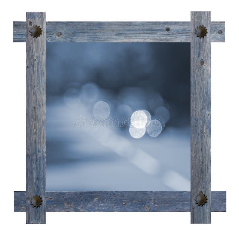 Old wooden blue frame with nails in shape of sun against a white background with blurred road, copy space in the center.  royalty free stock images