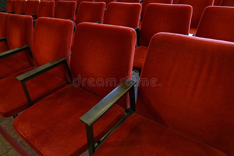 Rows of red soft chair seats close up. Close up red soft chair seats in a row, personal perspective, high angle view royalty free stock image Rows of red soft chair seats close up. Close up red soft chair seats in a row, personal perspective, high angle view royalty free stock image