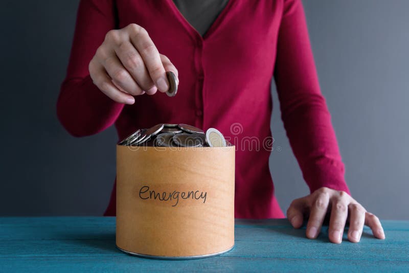 Saving Money for Emergency Concept. Woman putting Coin into a Bo. X stock images Saving Money for Emergency Concept. Woman putting Coin into a Bo. X stock images