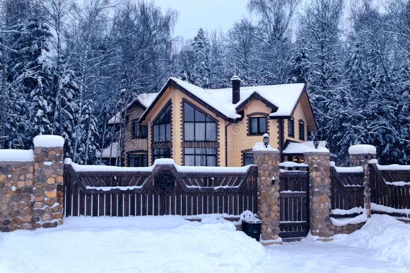 Snowy cottage in forest. Winter landscape with yellow wooden luxury house. Modern architecutre concept royalty free stock images Snowy cottage in forest. Winter landscape with yellow wooden luxury house. Modern architecutre concept royalty free stock images