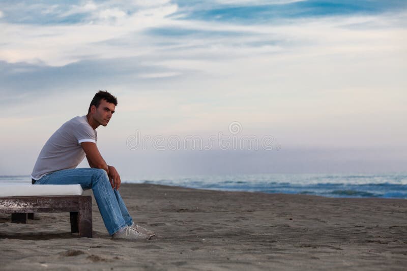 Solitude. Lonely man on the beach to the sea. stock image