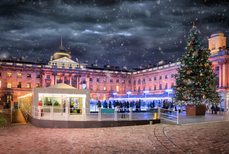 The Somerset House in London with a ice rink and christmas tree. During winter with snowfall stock photography The Somerset House in London with a ice rink and christmas tree. During winter with snowfall stock photography