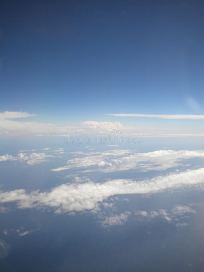 The stormy clouds shined from above with the sun. View from aeroplane royalty free stock photo