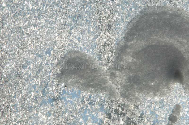 Texture, pattern. Winter photography. Picture of frost on the glass. Frozen water on the glass. a fantastic drawing, you will be. Right to use it in your design stock image
