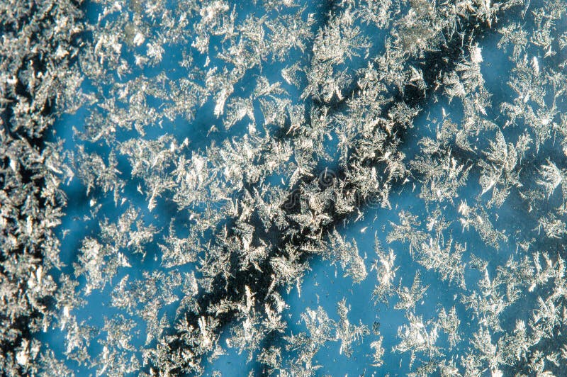 Texture, pattern. Winter photography. Picture of frost on the glass. Frozen water on the glass. a fantastic drawing, you will be. Right to use it in your design stock photos