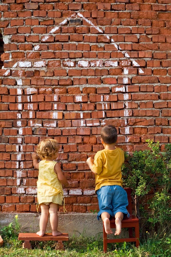 Two children drawing a house royalty free stock image