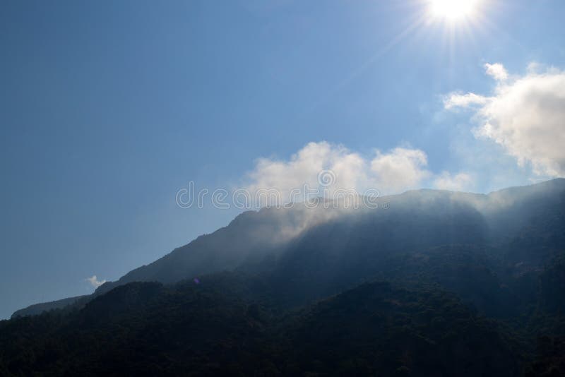 White clouds caught on a high mountain shined with the sun. Turkey stock image