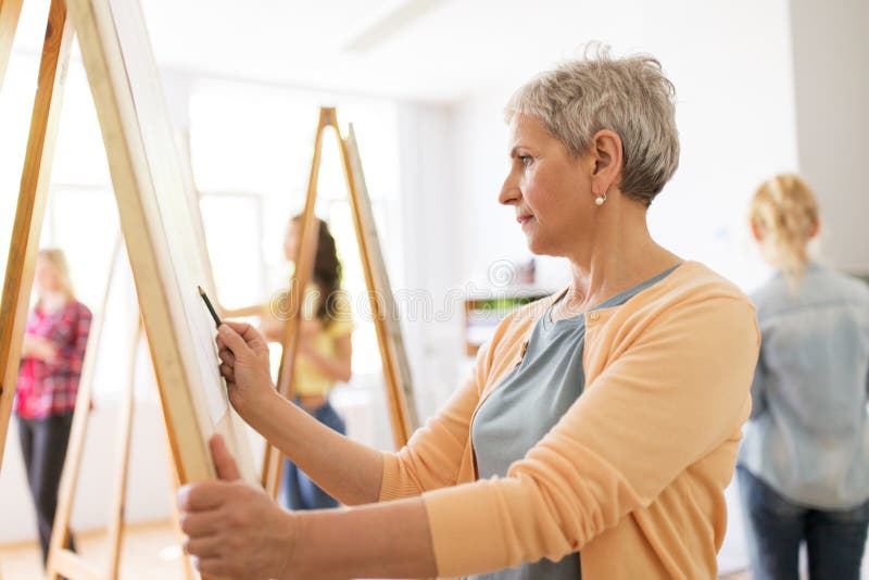 Woman artist with pencil drawing at art school stock photo