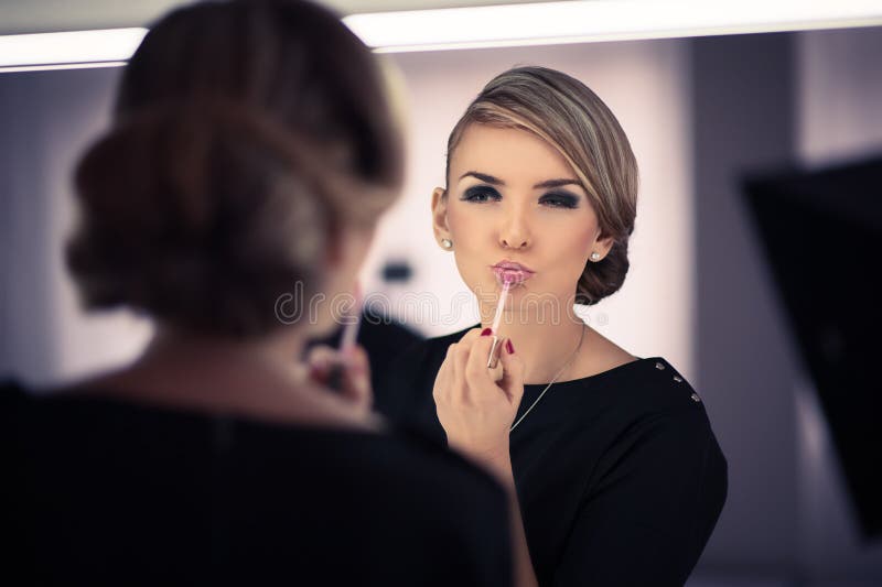 Young beautiful woman does a house make up royalty free stock image