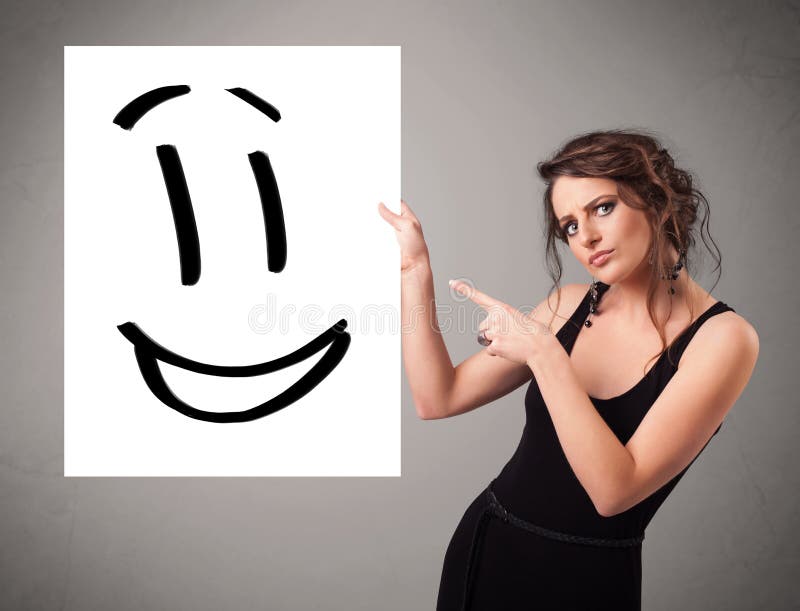 Young woman holding smiley face drawing. Attractive young woman holding smiley face drawing stock illustration