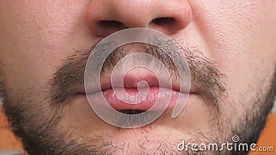 Close up lips of young bearded man. Detail view on closed male mouth. Portrait of handsome guy with serious and. Confident expression on the face. Front view stock footage