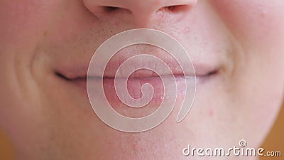 Close up lips of young man smiling with mouth closed. Portrait of handsome guy with glad expression on his face. Detail. View on happy male face. Front view stock video footage