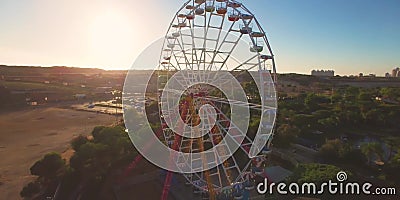 Aerial orbit shot on ferris wheel at country amusement park at sunset. colorful shot around Big wheel circle carousel stock video footage