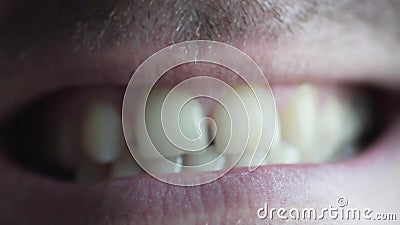 Male lips macro shooting. Close-up of a male mouth. He smiles and shows big teeth. There is light stubble on the man is face stock video footage