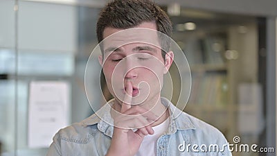 Portrait of Serious Young Male Designer Putting Finger on Lips. The Portrait of Serious Young Male Designer Putting Finger on Lips stock video footage