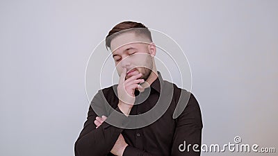 Seductive Male Finger Touches Lips, Crossed Hands, Sexuality And Flirting People. Young Bearded Dark Haired Man In Black Stylish Shirt On Gray Background stock video footage