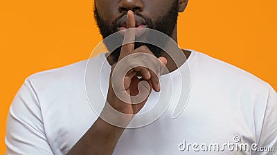 Young bearded male showing secret gesture, holding finger near lips, silence. Stock footage stock video footage